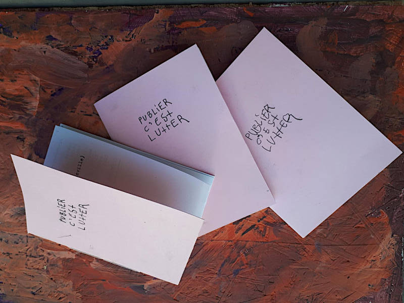 three small books with pink cover with handdrawn title