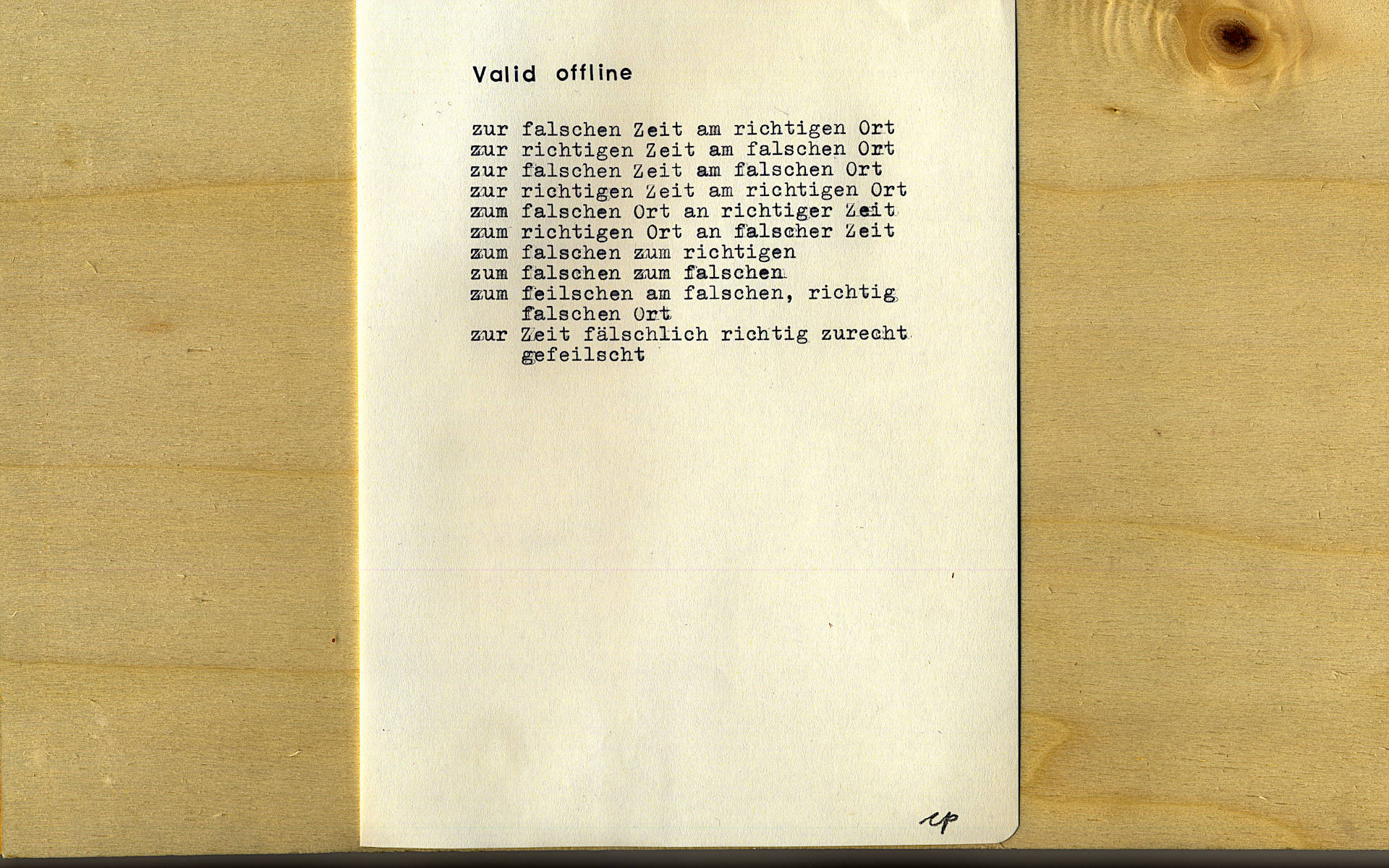 scan of the poem, written with a typewriter on a sheet of paper. in the background there is plywood.